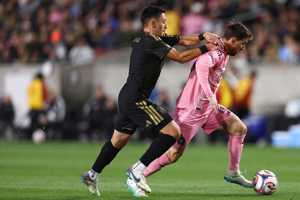Inter Miami forward Lionel Messi, right, dribbles against Los Angeles FC midfielder Mark Delgado, left, during the first half of an MLS soccer match, Saturday, Feb. 21, 2026, in Los Angeles, Calif. (AP Photo/Jessie Alcheh)
