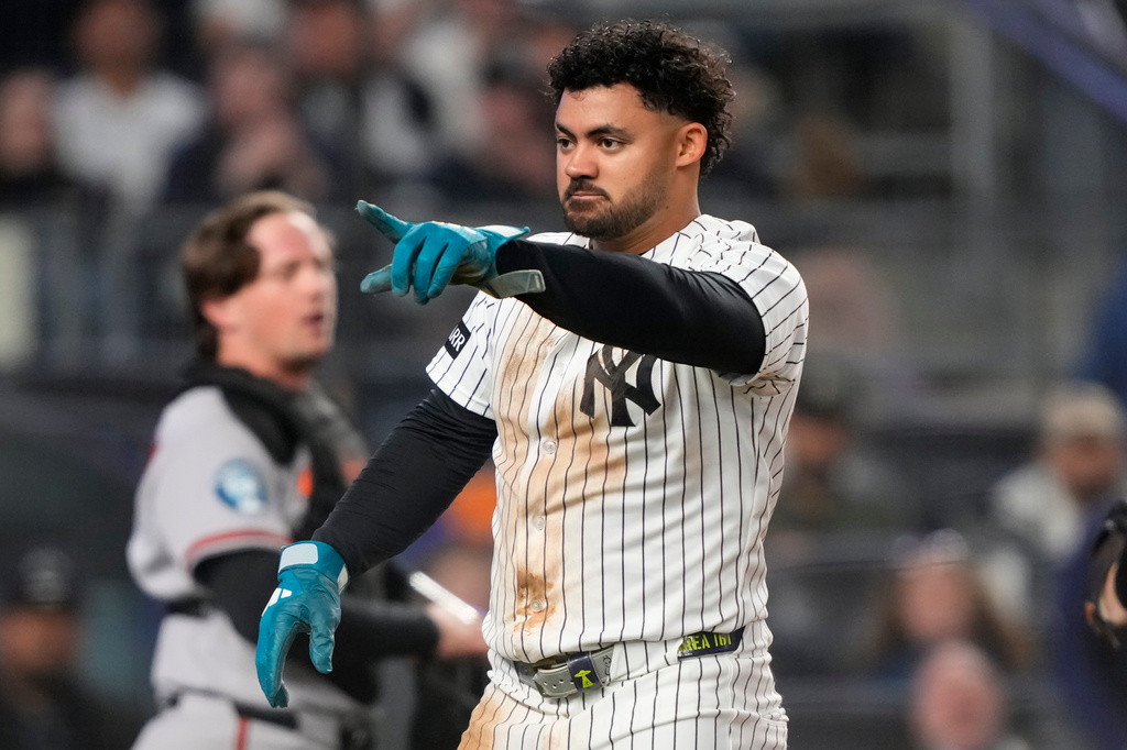 New York Yankees designated hitter Jasson Domínguez gestures after successfully sliding into home base to score on a wild pitch by Baltimore Orioles' Shane Baz during the sixth inning of a baseball game Monday, May 4, 2026, in New York. (AP Photo/Yuki Iwamura)