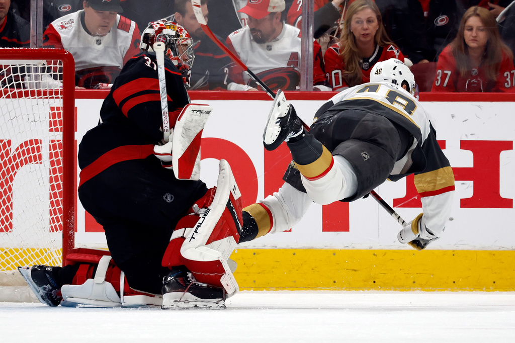 Vegas Golden Knights' Tomas Hertl (48) trips over Carolina Hurricanes goaltender Frederik Andersenn (31) during the second period in Game 1 of the NHL hockey Stanley Cup Final series in Raleigh, N.C., Tuesday, June 2, 2026. (AP Photo/Karl DeBlaker)