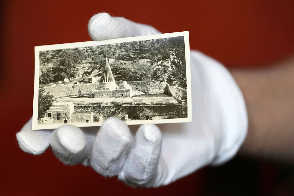 University of Pennsylvania doctoral student Marc Marin Webb displays an image from a collection of photos of the Yazidi people in their northern Iraq homeland in the 1930s, at the Penn Museum Archives in Philadelphia, Aug. 27, 2025. (AP Photo/Matt Rourke)