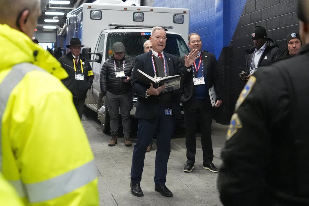 Chris Clark, Buffalo Bills Vice President of Security, center, meets with security personnel at Highmark Stadium before an NFL football game between the Philadelphia Eagles and Buffalo Bills, Sunday, Dec. 28, 2025. (AP Photo/Gene J. Puskar)