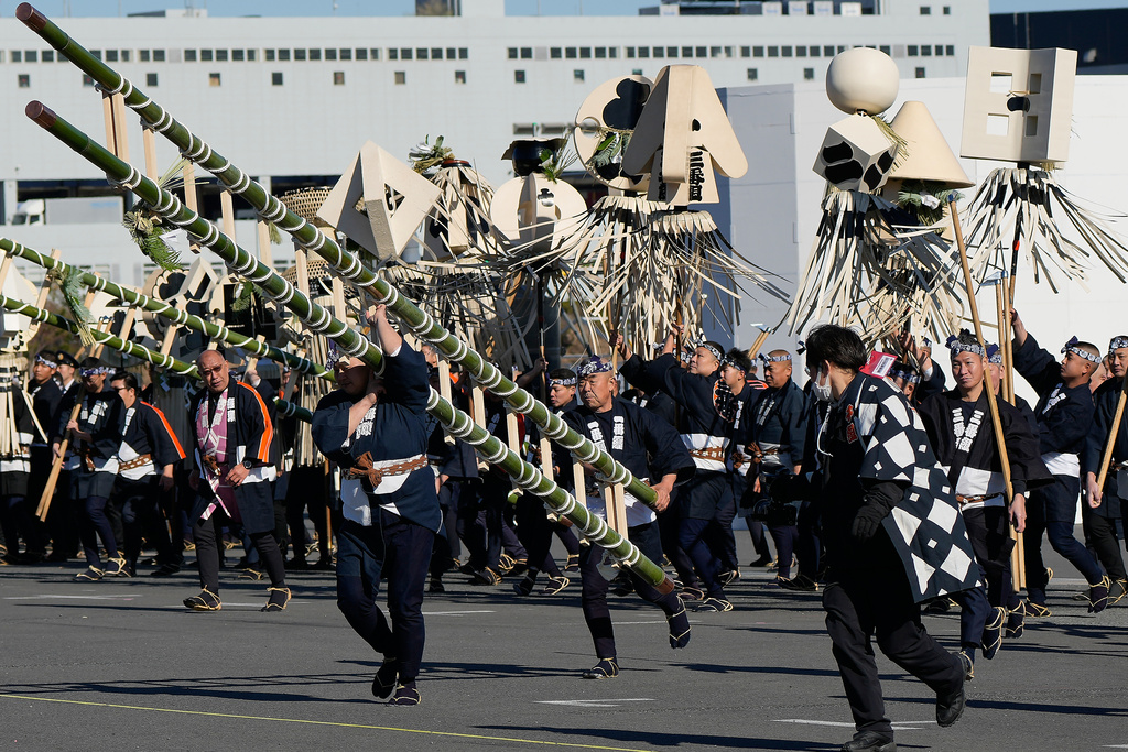 Members of a traditional firefighting preservation group dish to take positions to perform during the annual New Year's Fire Brigade Review Tuesday, Jan. 6, 2026, in Tokyo. (AP Photo/Eugene Hoshiko)
