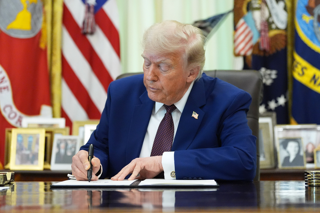 President Donald Trump signs an executive order in the Oval Office of the White House, Wednesday, June 3, 2026, in Washington. (AP Photo/Alex Brandon)