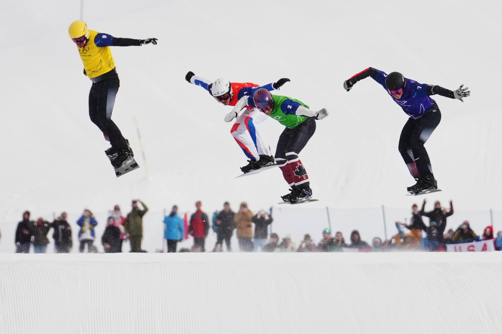 Austria's Alessandro Haemmerle (7), Canada's Eliot Grondin (2), Austria's Jakob Dusek (9) and France's Aidan Chollet (1) compete during the men's snowboard cross finals at the 2026 Winter Olympics, in Livigno, Italy, Thursday, Feb. 12, 2026. (AP Photo/Lindsey Wasson)