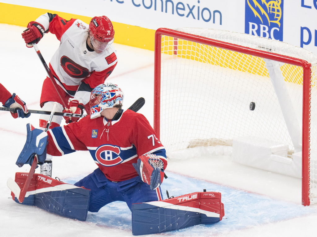 Carolina Hurricanes' Taylor Hall (71) scores on Montreal Canadiens goaltender Jakub Dobes (75) during the first period of an NHL hockey game in Montreal, Tuesday, Oct. 6, 2026. (Christinne Muschi/The Canadian Press via AP)