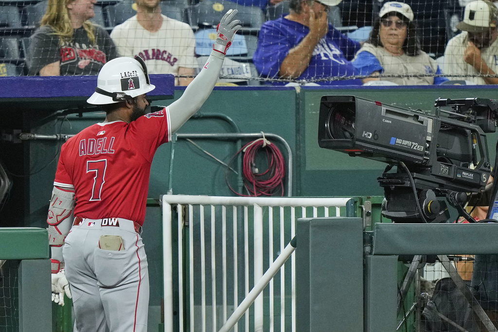 Los Angeles Angels' Jo Adell celebrates for a television camera after hitting a three-run home run during the sixth inning of a baseball game against the Kansas City Royals, Wednesday, Sept. 3, 2025, in Kansas City, Mo. (AP Photo/Charlie Riedel)