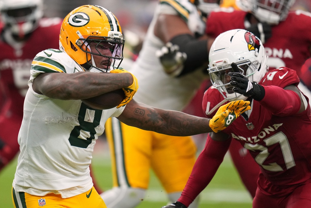 Green Bay Packers' Josh Jacobs tries to get past Arizona Cardinals' Akeem Davis-Gaither during the second half of an NFL football game Sunday, Oct. 19, 2025, in Glendale, Ariz. (AP Photo/Rick Scuteri)