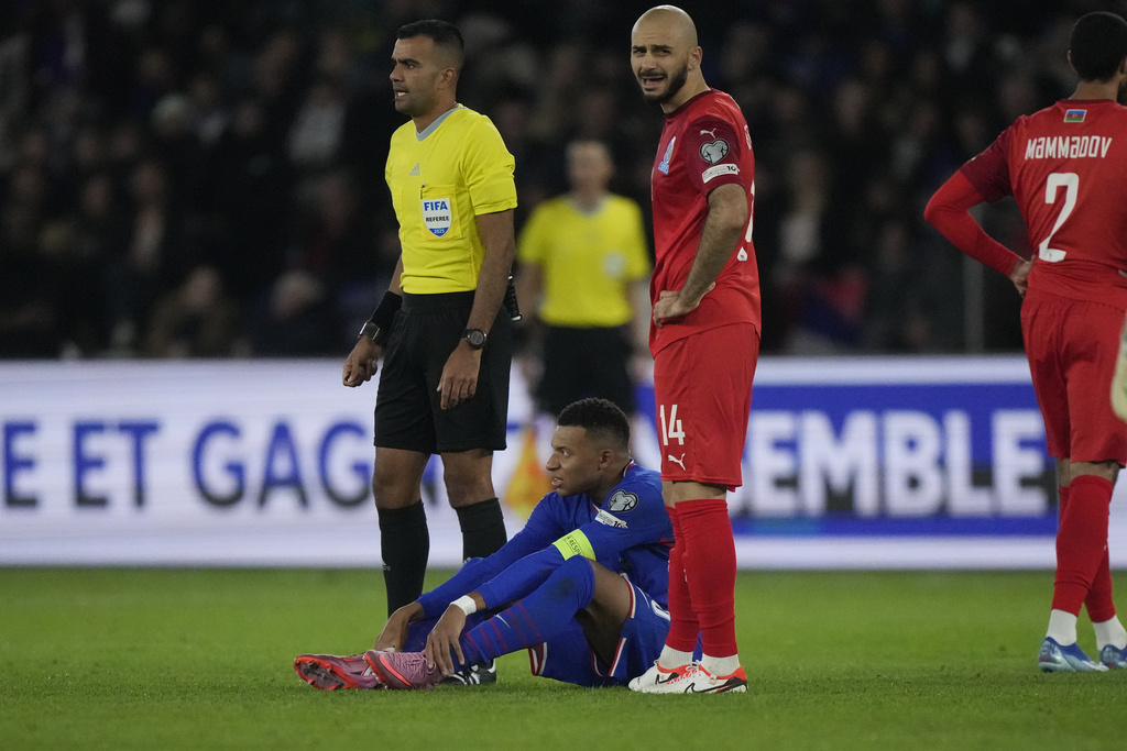 France's Kylian Mbappe sits injured during a World Cup 2026 Group D qualifying soccer match between France and Azerbaijan in Paris, France, on Friday, Oct. 10, 2025. (AP Photo/Michel Euler)