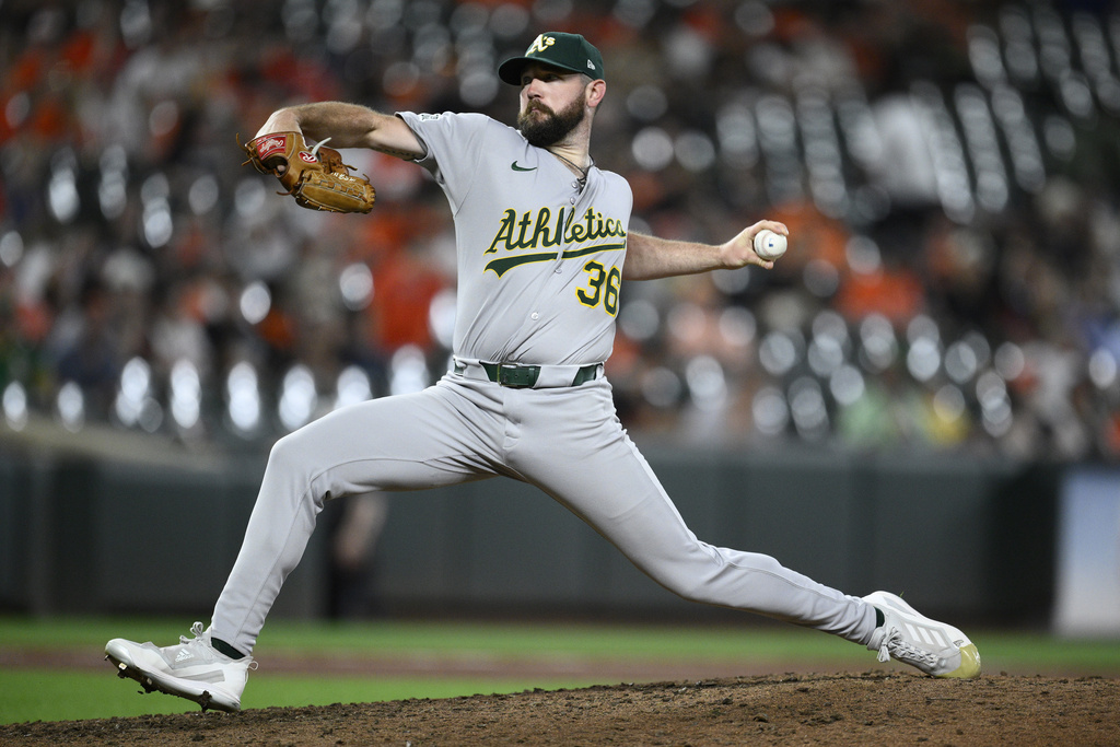 Athletics reliever Hogan Harris throws during the ninth inning of a baseball game against the Baltimore Orioles, Saturday, Aug. 9, 2025, in Baltimore. (AP Photo/Nick Wass)