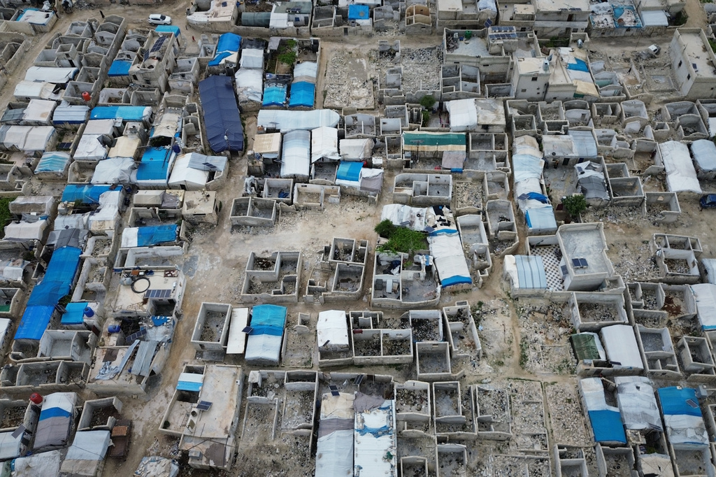 An aerial view of al-Karama camp, built from scratch with light-brick structures covered with fabric to house nternally displaced Syrians near the village of Atmeh, Idlib province, Syria, Tuesday, May 19, 2026.(AP Photo/Omar Albam)
