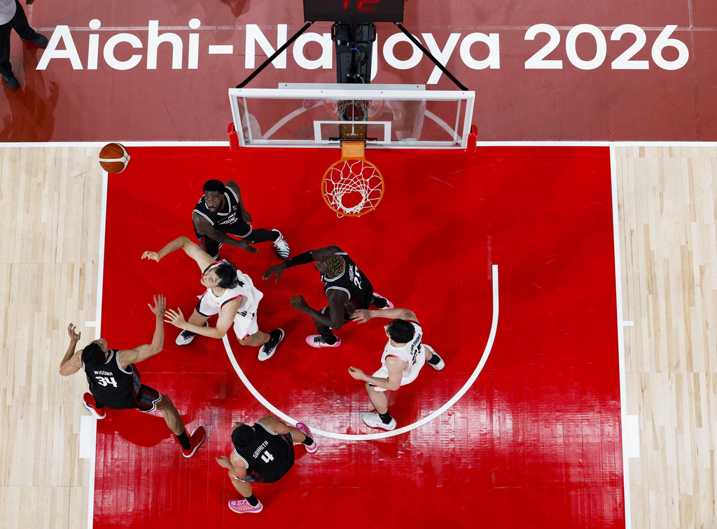 Team Japan players, in white, play against team Indonesia during their basketball game in the Asian Games in Nagoya, central Japan, on Sept. 10, 2026. (Jun Hirata/Kyodo News via AP)