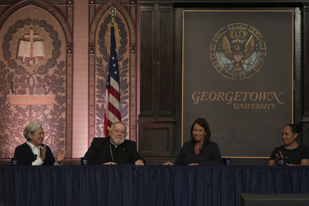 Sister Norma Pimentel (left) claps during a panel on the effects of the Trump administration's crackdown on immigrants held at Georgetown University in Washington, Thursday, Sept. 11, 2025. (AP Photo/Luis Andres Henao)