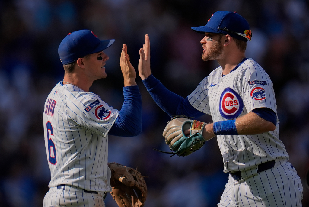 Chicago Cubs left fielder Ian Happ, right, and third baseman Matt Shaw (6) celebrate their team's win over the St. Louis Cardinals following a baseball game Saturday, Sept. 27, 2025, in Chicago. (AP Photo/Erin Hooley)