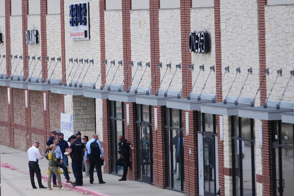 Officials respond to the scene of a shooting Tuesday, May 5, 2026, at K Towne Plaza in Carrollton, Texas. (AP Photo/Julio Cortez)