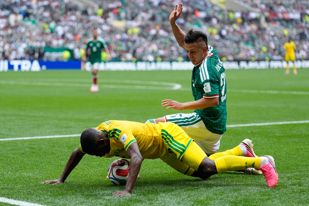 Mexico's Roberto Alvarado vies for the ball with South Africa's Aubrey Modiba, left, during the World Cup Group A soccer match between Mexico and South Africa in Mexico City, Thursday, June 11, 2026. (AP Photo/Natacha Pisarenko)