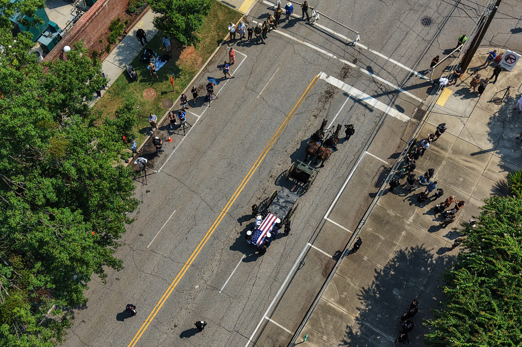 The casket of the late Sen. Lindsey Graham, R-S.C., is escorted to First Baptist Church in Columbia, S.C., for a funeral service, Wednesday, July 29, 2026. (AP Photo/Gerald Herbert)