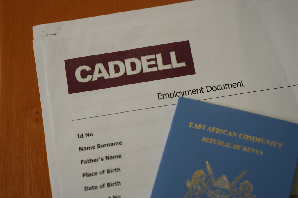 Employment documents and a passport belonging to a worker at the construction site of the new U.S. Consulate are seen in Milan, Italy, Monday, June 8, 2026, amid an investigation into alleged exploitative labor practices at the site. (AP Photo/Antonio Calanni)