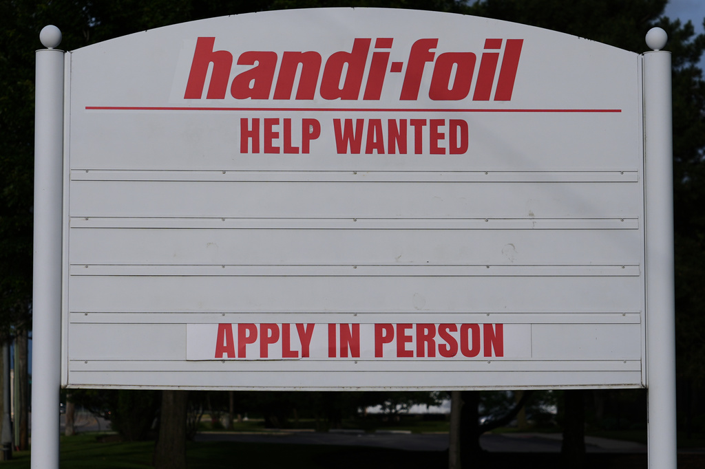 A help wanted sign is seen outside of a company in Wheeling, Ill., Monday, June 8, 2026. (AP Photo/Nam Y. Huh)
