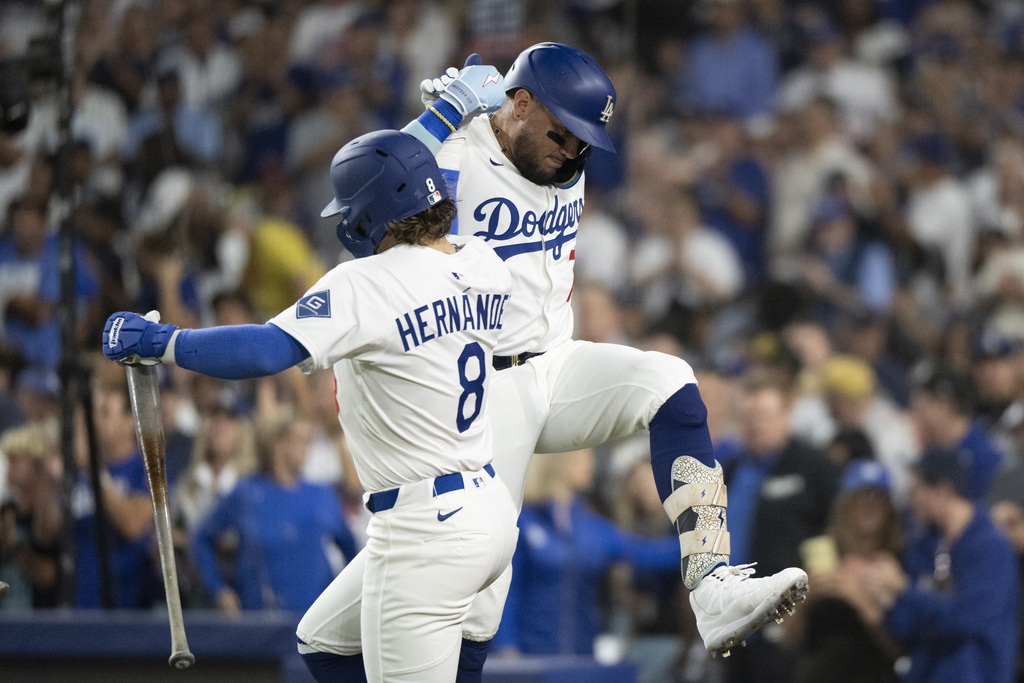 Los Angeles Dodgers' Miguel Rojas, right, and Kiké Hernández (8) celebrate Rojas' solo home run during the second inning of a baseball game against the San Francisco Giants in Los Angeles, Friday, Sept. 19, 2025. (AP Photo/Kyusung Gong)