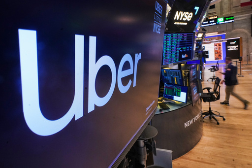 The logo for Uber is displayed above a trading post on the floor of the New York Stock Exchange, Monday, Oct. 20, 2025. (AP Photo/Richard Drew) The logo for Uber is displayed above a trading post on the floor of the New York Stock Exchange, Monday, Oct. 20, 2025. (AP Photo/Richard Drew)