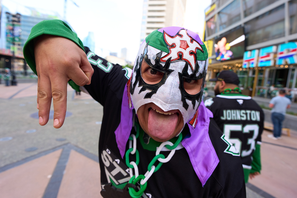 A Dallas Stars fan shows off his Lucha Libre wrestling mask as he arrives for an NHL hockey game against the Vegas Golden Knights in Dallas, Tuesday, March 10, 2026. (AP Photo/Tony Gutierrez)