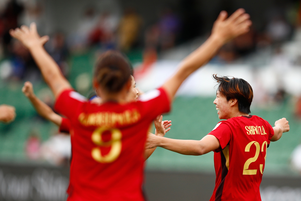 China's Shao Ziqin, right, celebrates after scoring her team's first goal during the Women's Asian Cup quarterfinal soccer match between China and Taiwan in Perth, Australia, Saturday, March 14, 2026. (AP Photo/Gary Day)