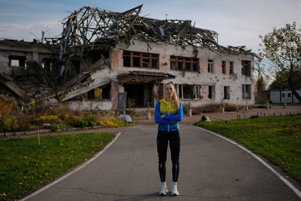 Biathlete Khrystyna Dmytrenko poses for photos outside the destroyed ski base in Chernihiv, Ukraine, Thursday, Oct. 30, 2025. (AP Photo/Julia Demaree Nikhinson)