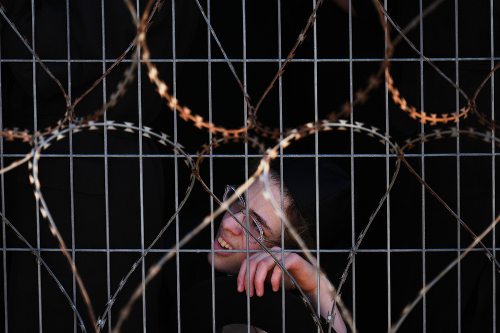 Ultra-Orthodox Jewish men protest against military recruitment and call for the release of detained draft resisters outside a military prison near Kfar Yona, Israel, Wednesday, June 17, 2026. (AP Photo/Ariel Schalit)
