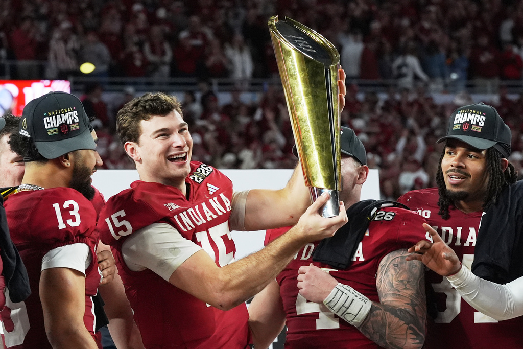 Indiana quarterback Fernando Mendoza holds the trophy after their win against Miami in the College Football Playoff national championship game, Monday, Jan. 19, 2026, in Miami Gardens, Fla. (AP Photo/Marta Lavandier)
