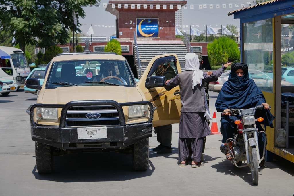 A Taliban security officer searches a man at a checkpoint ahead of celebrations marking the fifth anniversary of the U.S. withdrawal from Afghanistan and the start of Taliban rule, in Kabul, Afghanistan, Thursday, Aug. 13, 2026. (AP Photo/Siddiqullah Alizai)