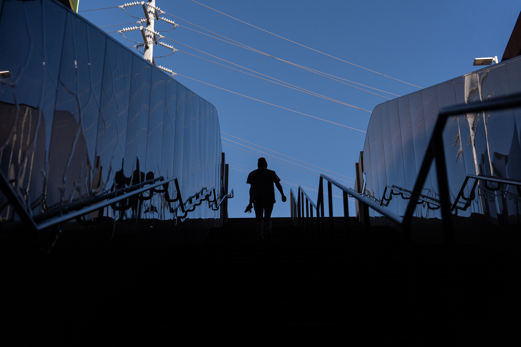 Quantavia Smith walks up the steps of a metro station next to the Santa Monica and Vermont Apartments, where she lives, in Los Angeles, Monday, Nov. 10, 2025. (AP Photo/Jae C. Hong)