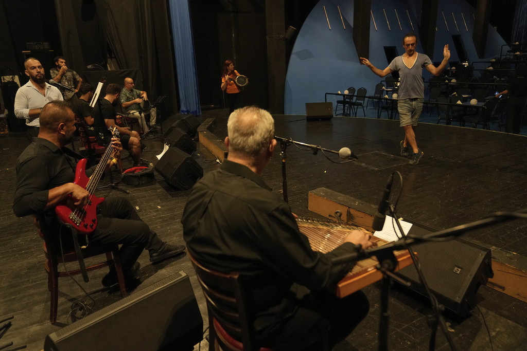 Alexandre Paulikevitch rehearses with musicians at a theatre in Beirut, Lebanon, Thursday, Sept. 11, 2025. (AP Photo/Hussein Malla)