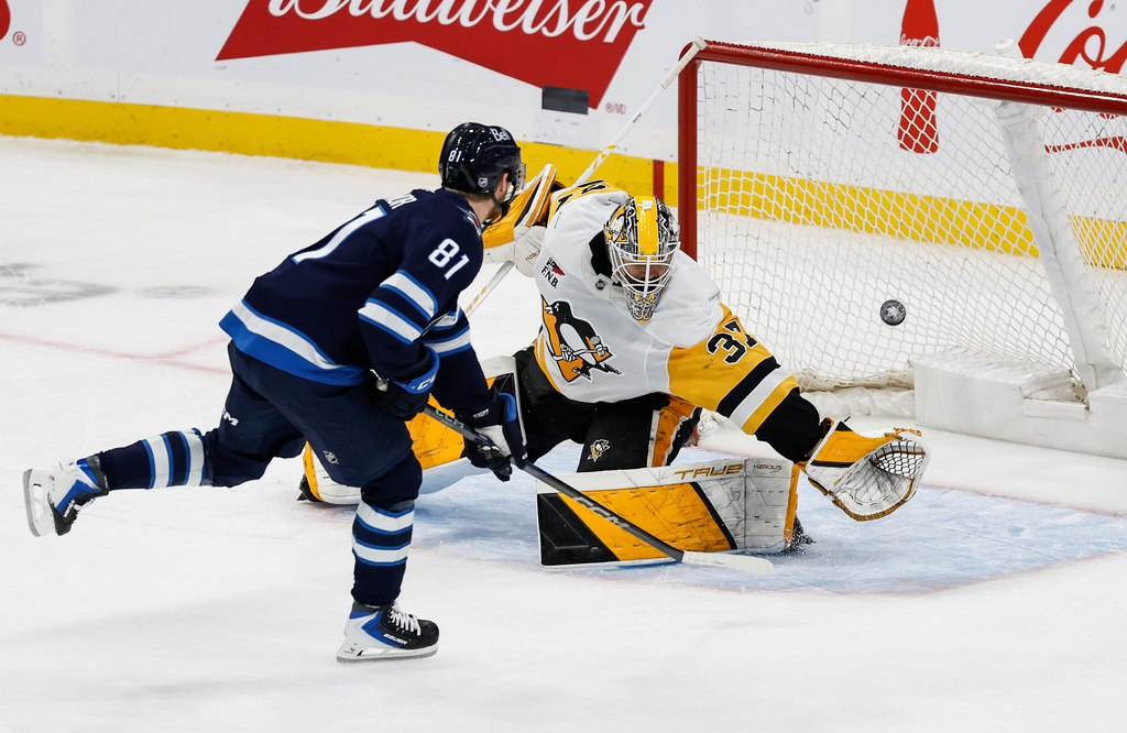 Winnipeg Jets' Kyle Connor (81) scores on a penalty shot against Pittsburgh Penguins goaltender Arturs Silovs (37) during the second period of an NHL hockey game, Saturday, Nov. 1, 2025, in Winnipeg, Manitoba. (John Woods/The Canadian Press via AP)