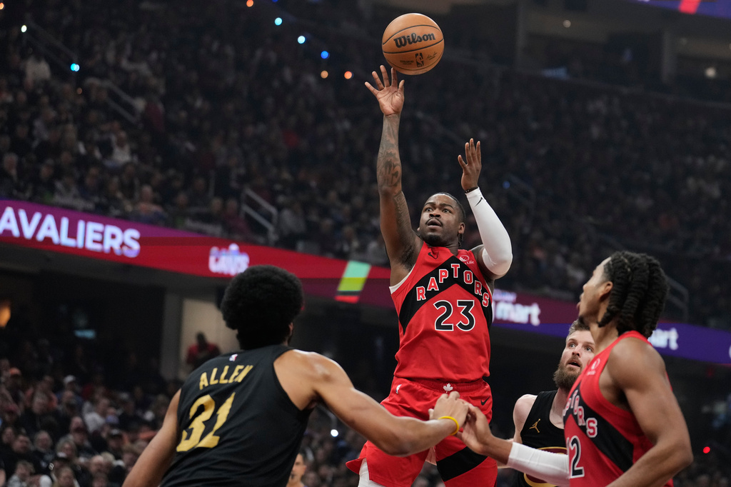 Toronto Raptors guard Jamal Shead (23) shoots over Cleveland Cavaliers center Jarrett Allen (31) in the first half in Game 7 of a first-round NBA basketball playoffs series in Cleveland, Sunday, May 3, 2026. (AP Photo/Sue Ogrocki)