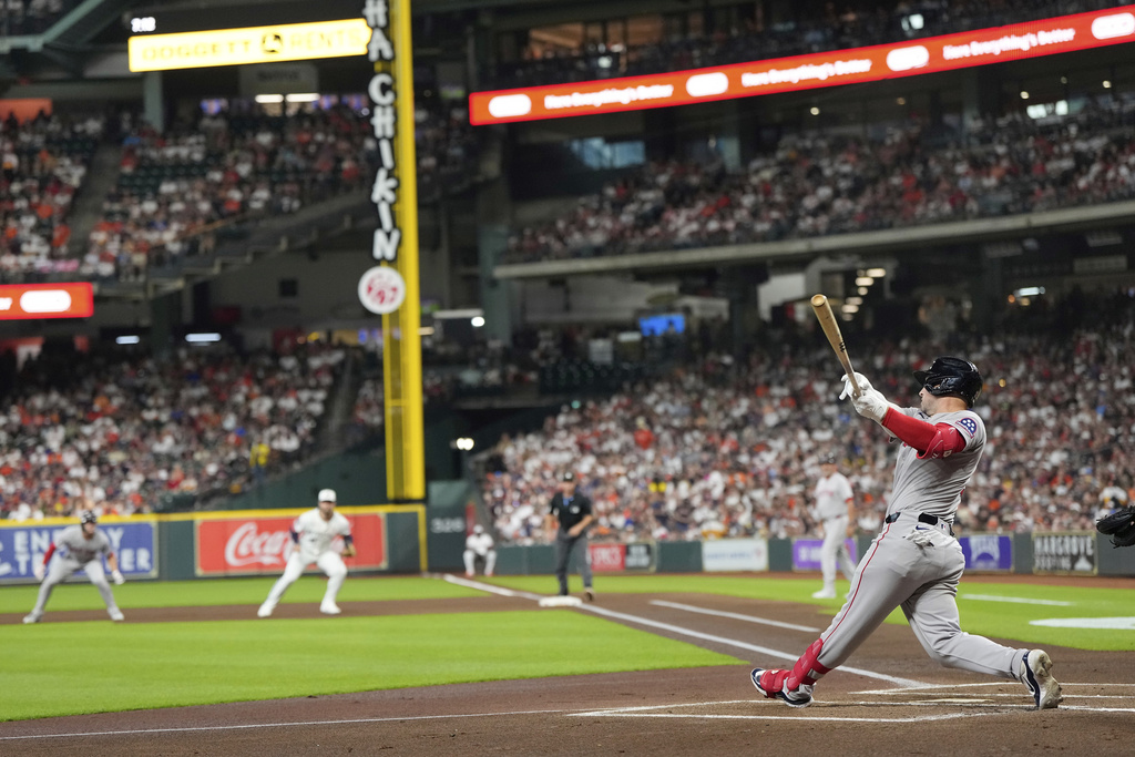 Boston Red Sox's Alex Bregman hits a two-run home run against the Houston Astros during the first inning of a baseball game Monday, Aug. 11, 2025, in Houston. (AP Photo/David J. Phillip)