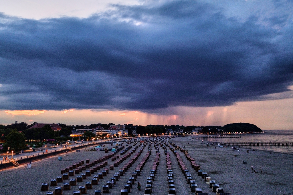A thunderstorm moves over the beach of the Baltic Sea in Travemuende, Germany, late Saturday, June 20, 2026. (AP Photo/Michael Probst)
