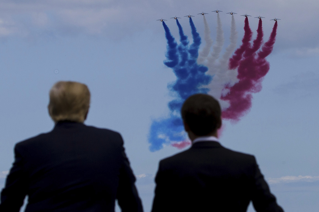 FILE - President Donald Trump, left, and French President Emmanuel Macron watch a flyover during a ceremony to commemorate the 75th anniversary of D-Day at the American Normandy cemetery, June 6, 2019, in Colleville-sur-Mer, Normandy, France. (AP Photo/Alex Brandon, File)