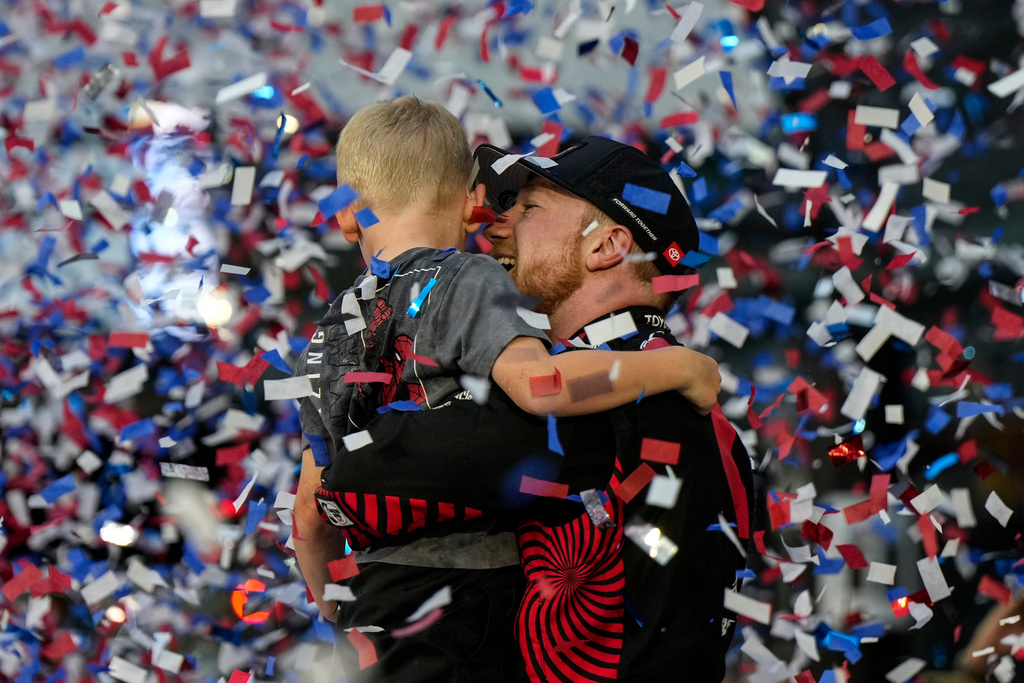 Tyler Reddick, (45) and his son Beau celebrate with the team after winning the NASCAR Daytona 500 auto race at Daytona International Speedway, Sunday, Feb. 15, 2026, in Daytona Beach, Fla. (AP Photo/Nigel Cook)