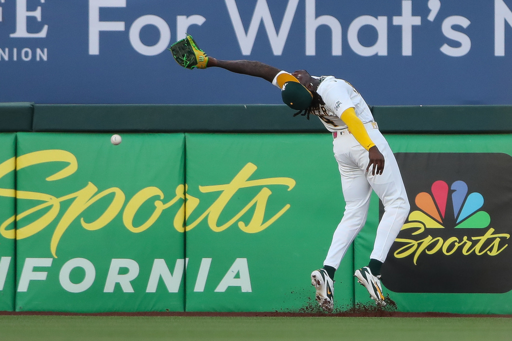 Athletics right fielder Lawrence Butler over runs the ball and can't make the catch during the fifth inning of a baseball game against the Pittsburgh Pirates Wednesday, June 17, 2026, in West Sacramento, Calif. (AP Photo/Scott Marshall)