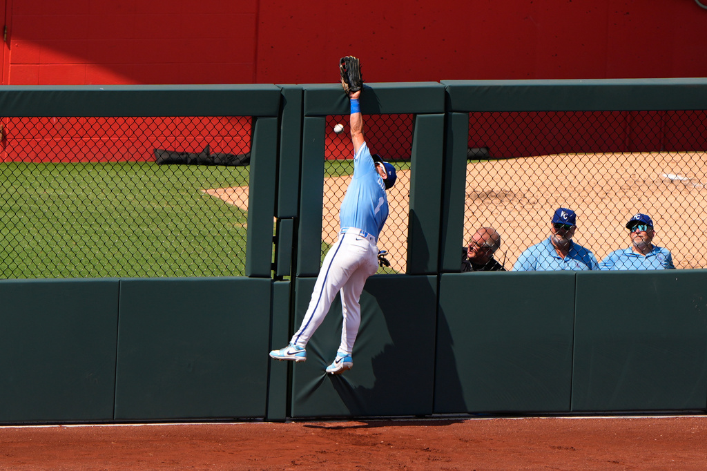 Kansas City Royals left fielder Isaac Collins can't get to a grand slam hit by San Diego Padres' Ty France during the eighth inning of a baseball game Sunday, July 19, 2026, in Kansas City, Mo. (AP Photo/Charlie Riedel)