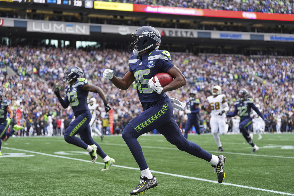 Seattle Seahawks wide receiver Tory Horton (15) returns a punt for a touchdown during the first half of an NFL football game against the New Orleans Saints, Sunday, Sept. 21, 2025, in Seattle. (AP Photo/Lindsey Wasson)