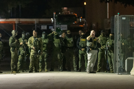 Federal law enforcement officers stand guard in the open gate of the fence built on Beach Street outside the Broadview ICE processing facility in suburban Broadview, Tuesday, Oct. 14, 2025. (Tyler Pasciak LaRiviere/Chicago Sun-Times via AP) Federal law enforcement officers stand guard in the open gate of the fence built on Beach Street outside the Broadview ICE processing facility in suburban Broadview, Tuesday, Oct. 14, 2025. (Tyler Pasciak LaRiviere/Chicago Sun-Times via AP)