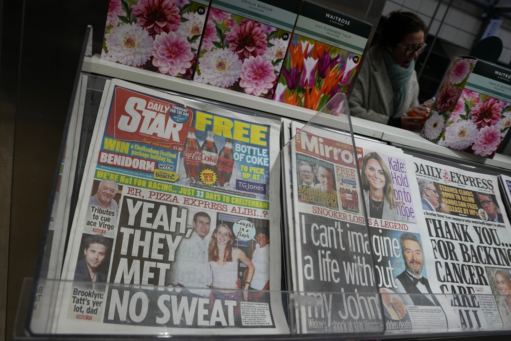 Newspaper front pages are on display at a News agent in London, Thursday, Feb. 5, 2026. (AP Photo/Kin Cheung)