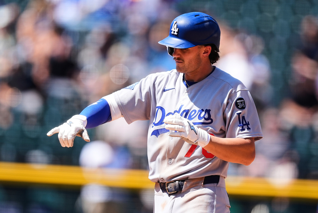 Los Angeles Dodgers' Alex Freeland gestures after hitting a double to drive in a run off Colorado Rockies starting pitcher Chase Dollander in the fourth inning of a baseball game Thursday, Aug. 21, 2025, in Denver. (AP Photo/David Zalubowski)