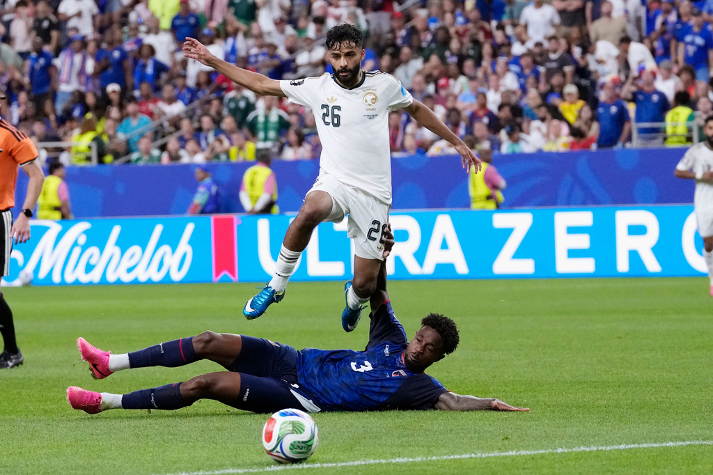 Cape Verde's Diney Borges (3) slides under Saudi Arabia's Mohammed Abu Alshamat (26) during the second half of the World Cup Group H soccer match between Cape Verde and Saudi Arabia in Houston, Friday, June 26, 2026. (AP Photo/David J. Phillip)