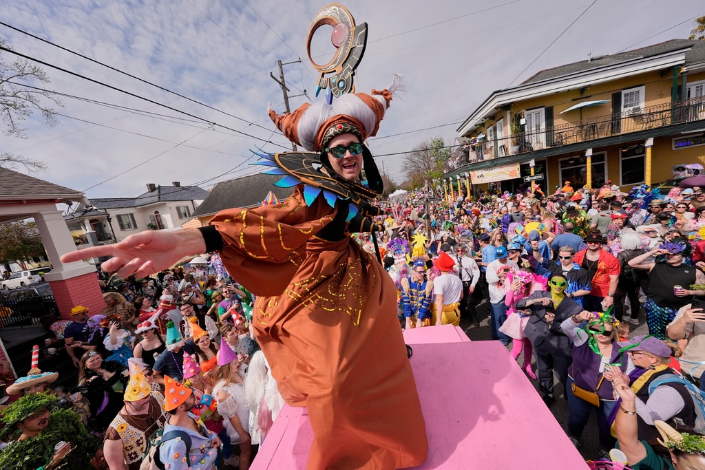 FILE- People gather for the start of the Society of Saint Anne's parade on Mardi Gras Day, March 4, 2025 in New Orleans. (AP Photo/Gerald Herbert, File)