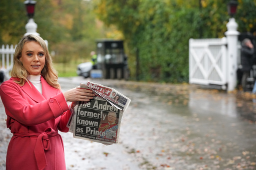 A TV presenter holds a newspaper with a picture of prince Andrew as she talks to the camera at a gate near to the Royal Lodge, following the announcement that Prince Andrew will be stripped of his titles and leave the 30-room mansion he has occupied for more than 20 years in Windsor, England, Friday, Oct. 31, 2025.(AP Photo/Alastair Grant) A TV presenter holds a newspaper with a picture of prince Andrew as she talks to the camera at a gate near to the Royal Lodge, following the announcement that Prince Andrew will be stripped of his titles and leave the 30-room mansion he has occupied for more than 20 years in Windsor, England, Friday, Oct. 31, 2025.(AP Photo/Alastair Grant)