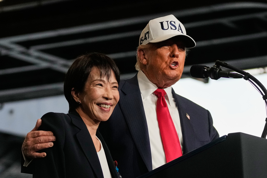President Donald Trump, with Japanese Prime Minister Sanae Takaichi, speaks to members of the military aboard the USS George Washington, an aircraft carrier docked at an American naval base, in Yokosuka, Tuesday, Oct. 28, 2025. (AP Photo/Mark Schiefelbein)