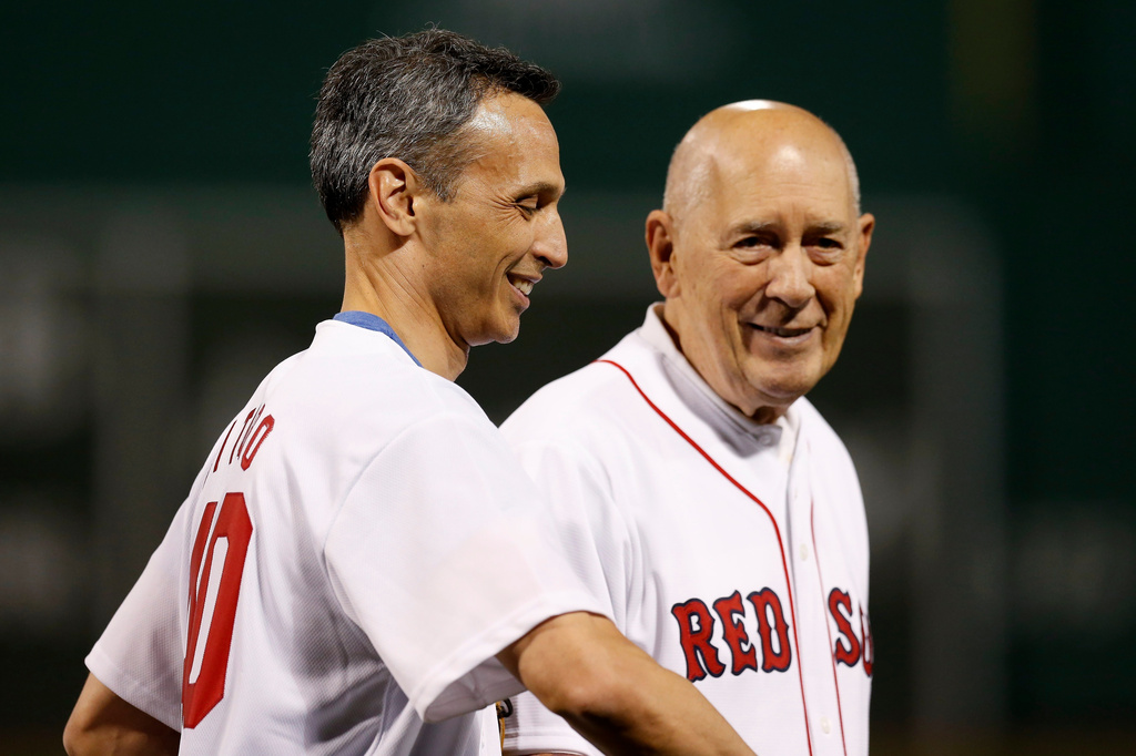 FILE - President of ESPN James Pitaro, left, walks off the field after catching the ceremonial first pitch from ESPN founder Bill Rasmussen, right, before a baseball game between the Boston Red Sox and the New York Yankees in Boston, Sunday, Sept. 8, 2019. (AP Photo/Michael Dwyer, File)