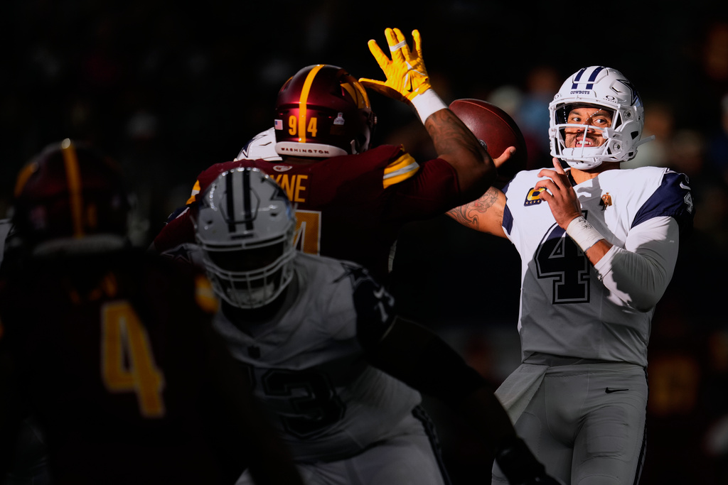 Dallas Cowboys quarterback Dak Prescott (4) attempts a pass as Washington Commanders nose tackle Daron Payne (94) defends during the second half of an NFL football game Sunday, Oct. 19, 2025, in Arlington, Texas. (AP Photo/Jeffrey McWhorter)